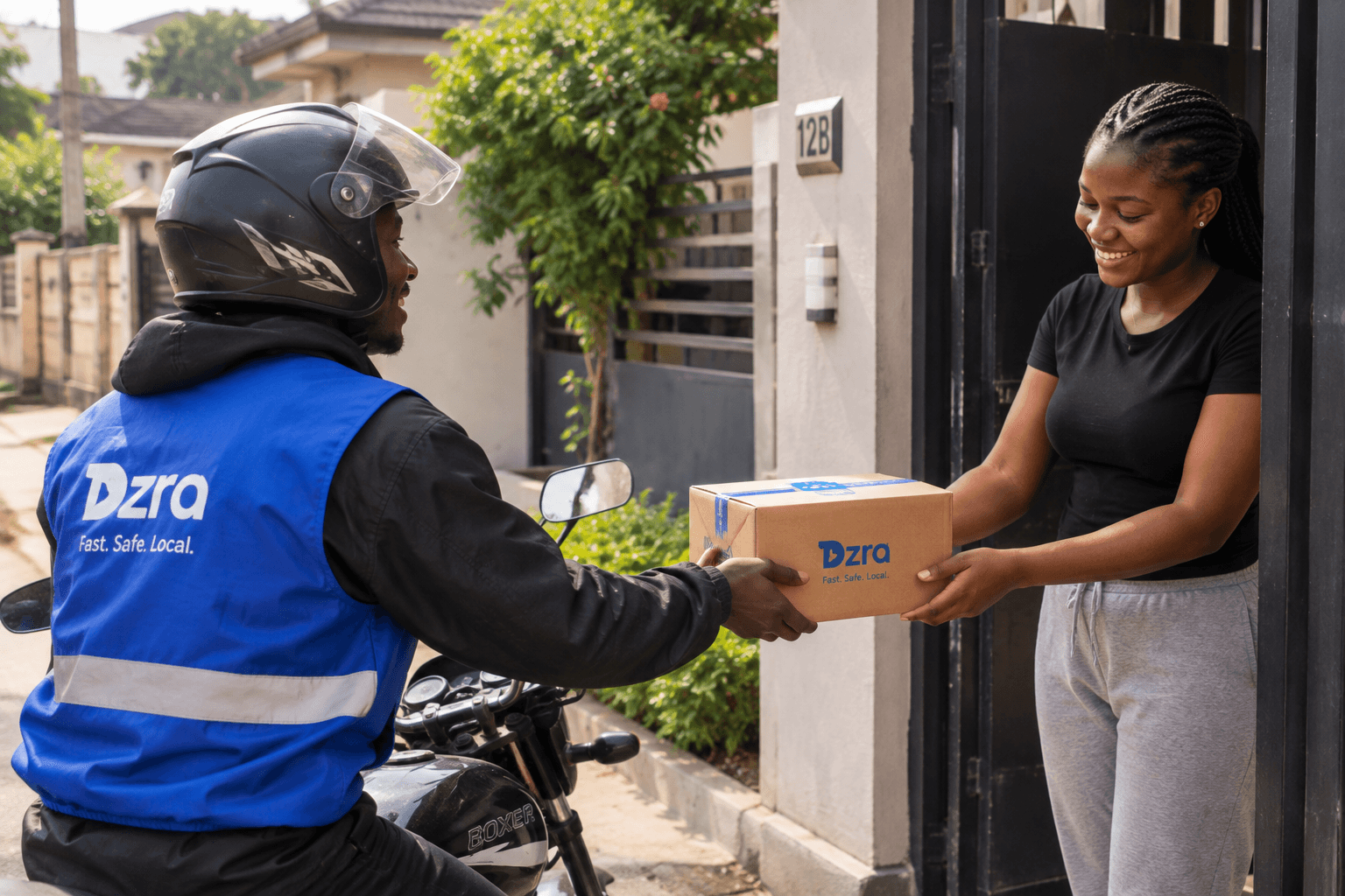 A delivery rider handing a parcel to a smiling customer at her front gate